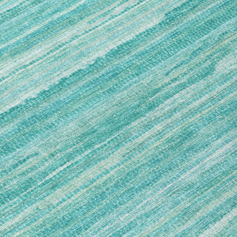Close-up of teal and aqua striped area rug with subtle horizontal weave texture