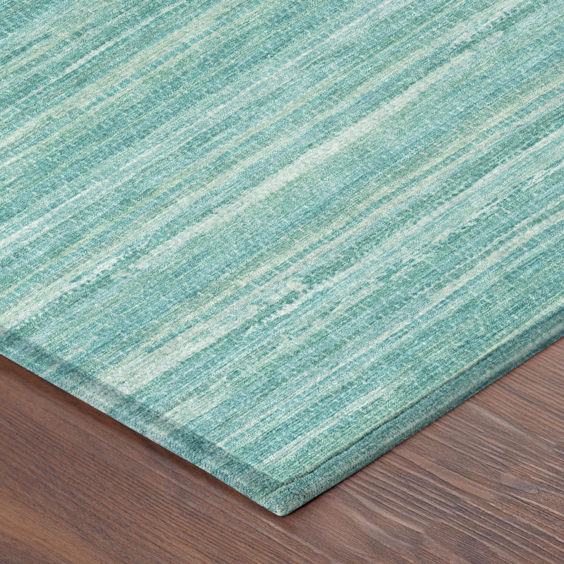 Corner of teal and aqua striped area rug with thin horizontal bands and border