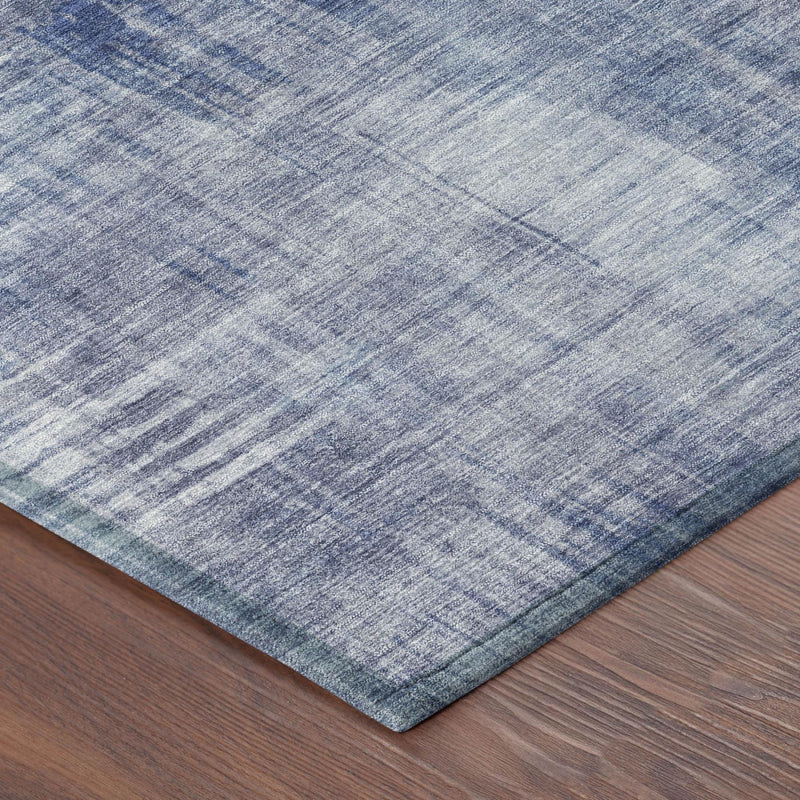 Blue abstract area rug corner with visible low-pile edge