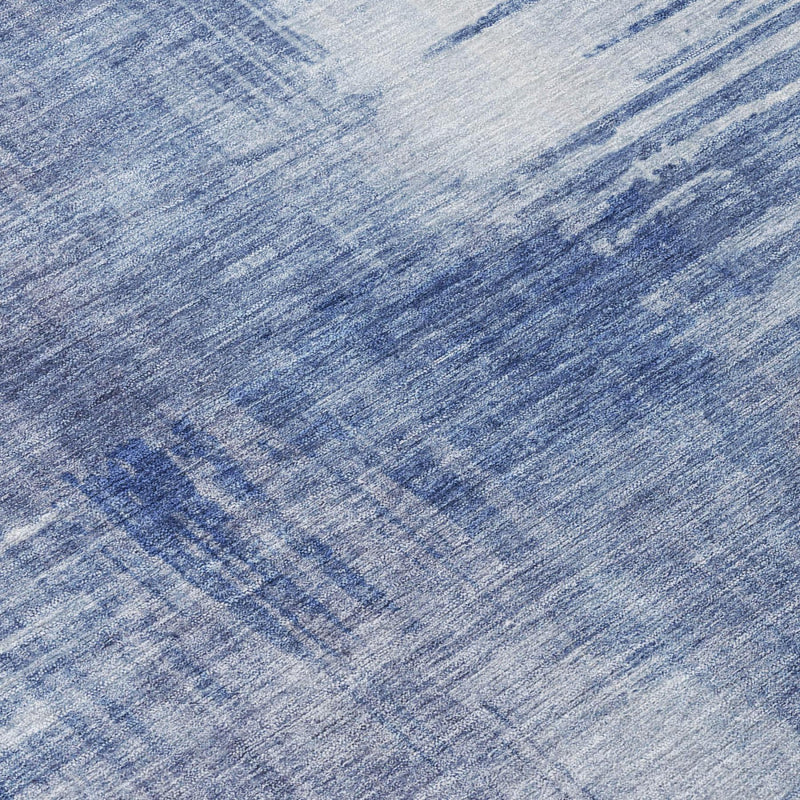 Blue abstract area rug close-up with distressed textured weave