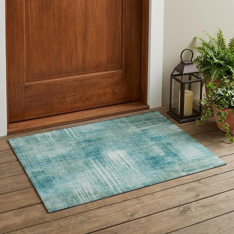 Teal blue and blue abstract area rug, rectangular shape with distressed pattern