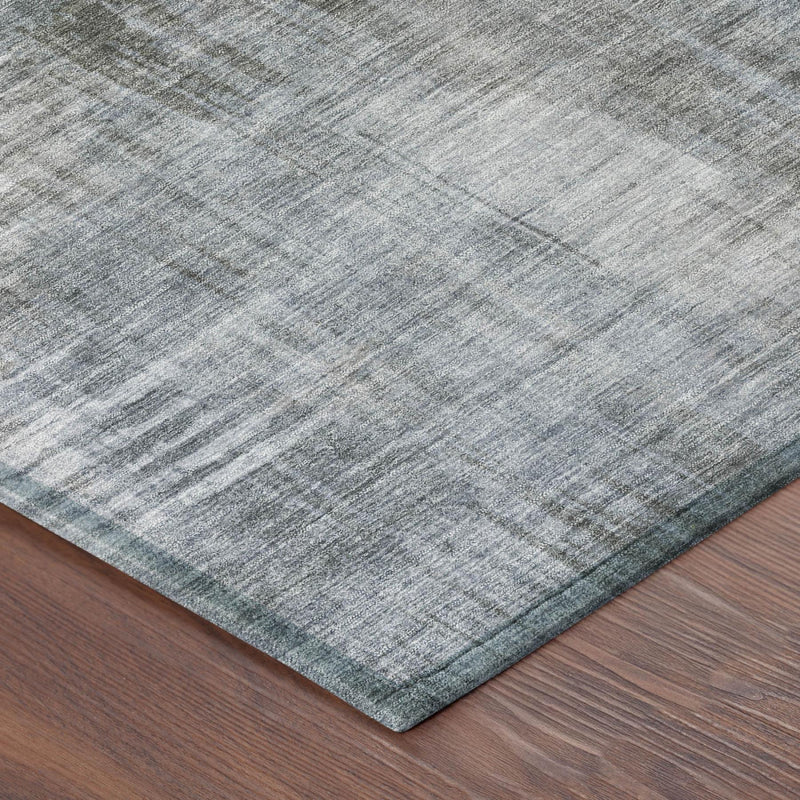 Corner view of abstract washed rug in gray and blue-gray with textured border