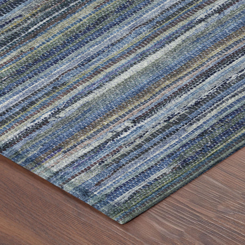 Blue and gray striped area rug laid flat on wood floor, angled view