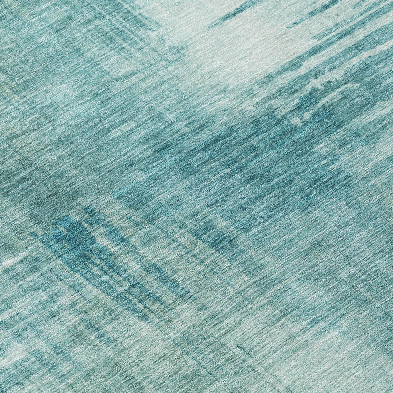 Close-up of teal and blue abstract rug texture with washed streak pattern