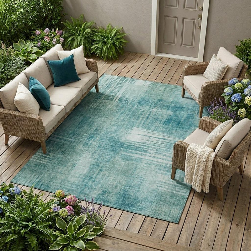 Teal and blue abstract washable area rug in a living outdoor seating area
