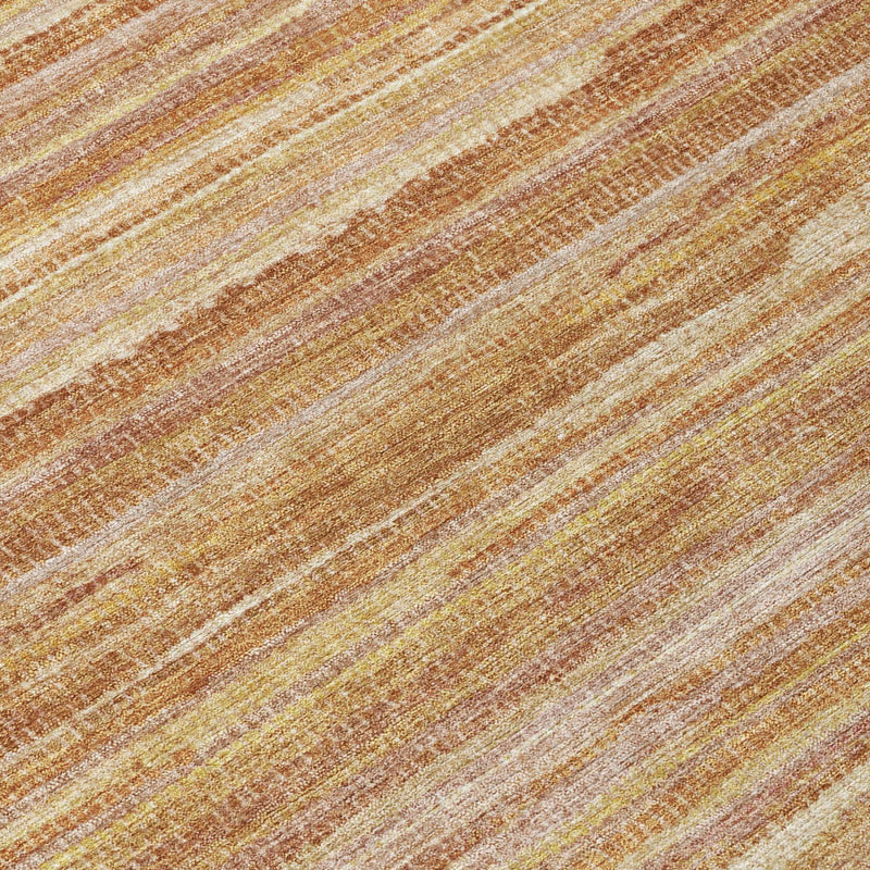 Close-up of round rug stripes in copper, orange, and cream with textured woven look
