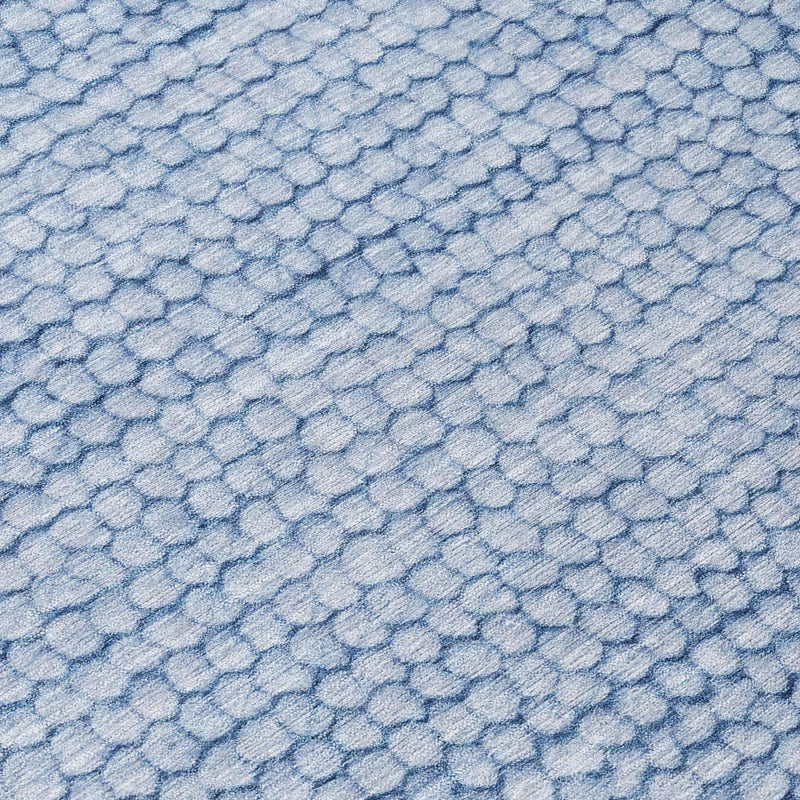 Close-up of light blue washable indoor/outdoor area rug with pebble pattern texture