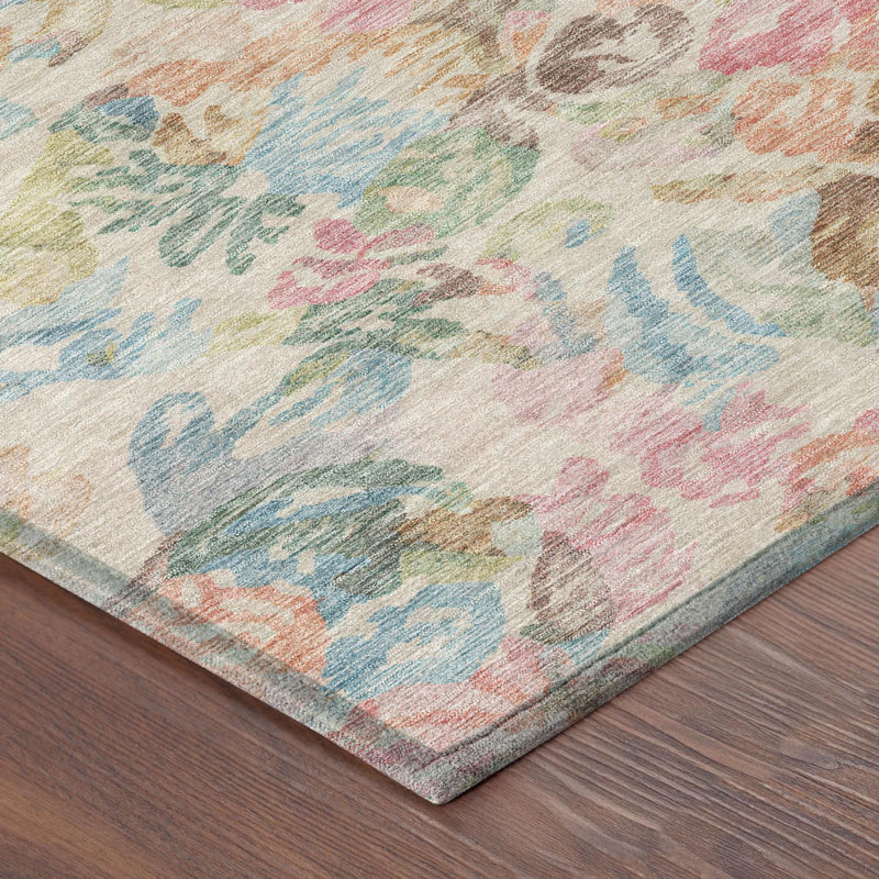 Corner view of pastel floral area rug on dark wood floor; thin border around multicolor print.