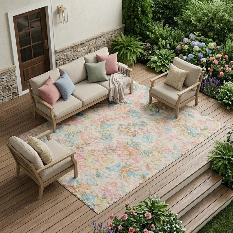 Indoor/outdoor living space with pastel floral area rug; pink, tan, blue, green, and orange pattern.