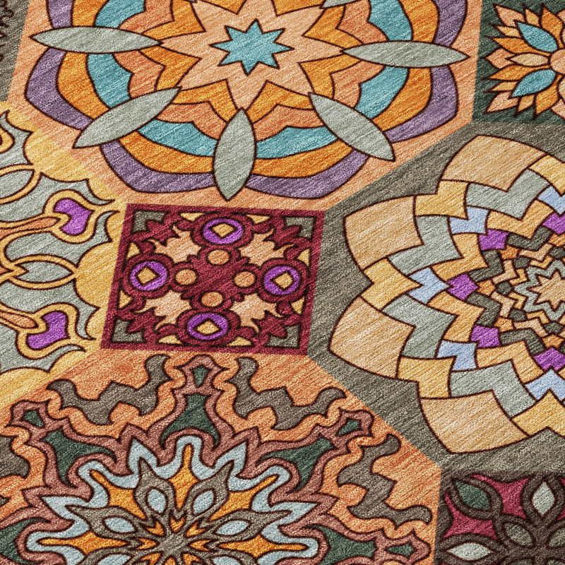 Closeup patchwork rug with orange, tan, purple and gray geometric floral blocks