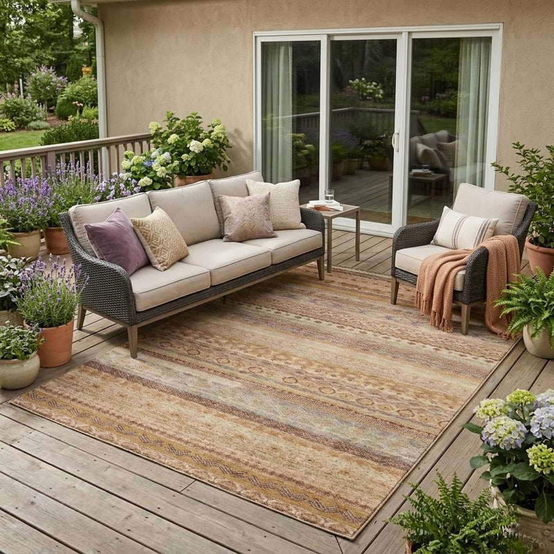 Orange, copper, and beige striped indoor/outdoor area rug with geometric trim