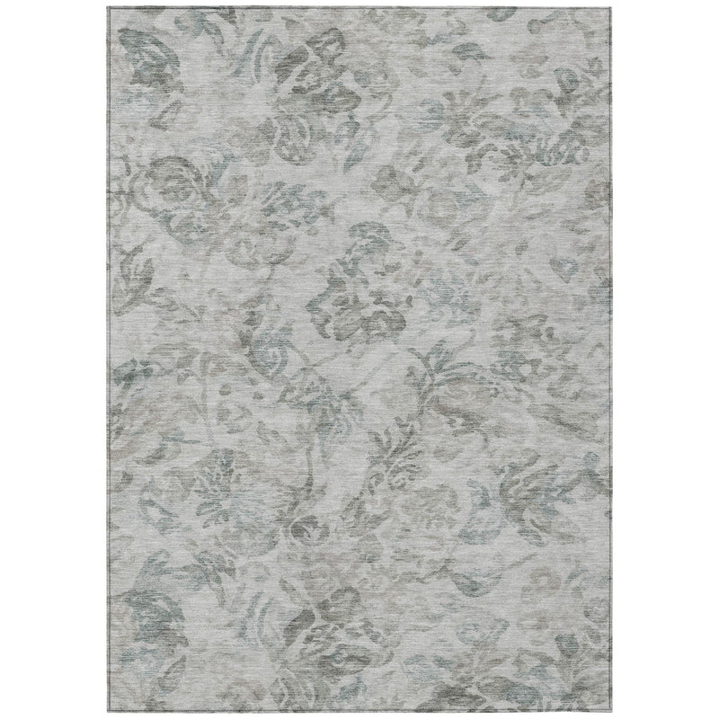 Indoor/outdoor area rug with light gray ground and faded teal floral motif