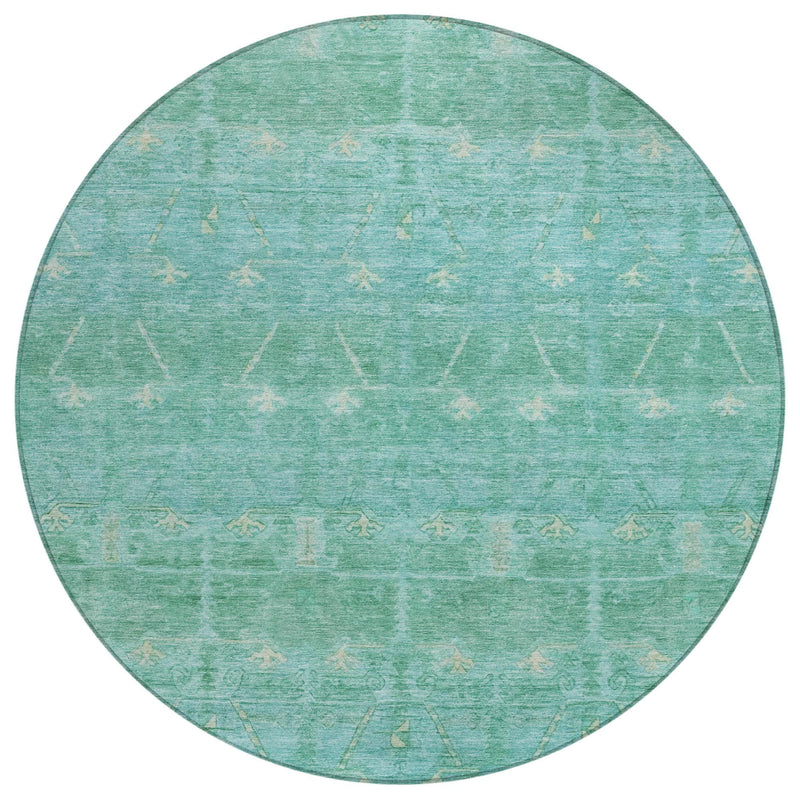 Round teal-green area rug with faded tribal motifs and light distressed texture