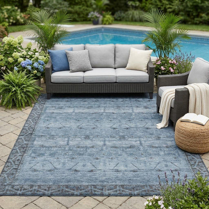 Outdoor patio area rug in blue and gray with distressed tribal pattern