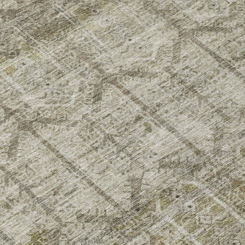 Close-up of beige rug with brown tribal motif, distressed wash texture