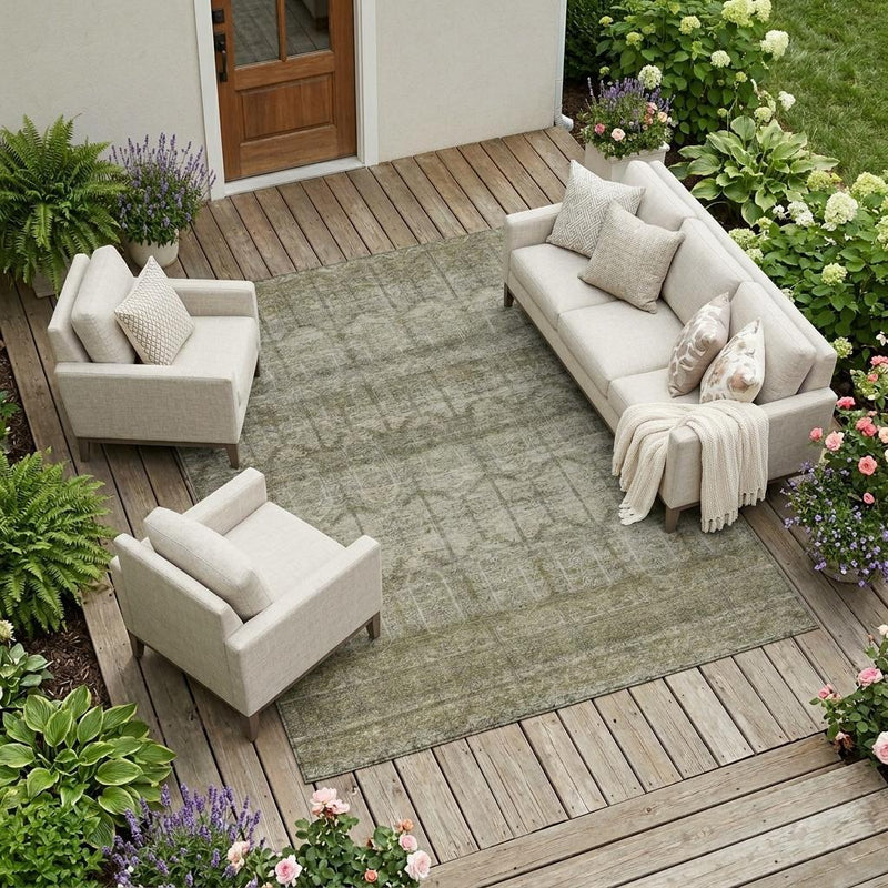 Beige and brown tribal area rug on outdoor wooden deck with seating set