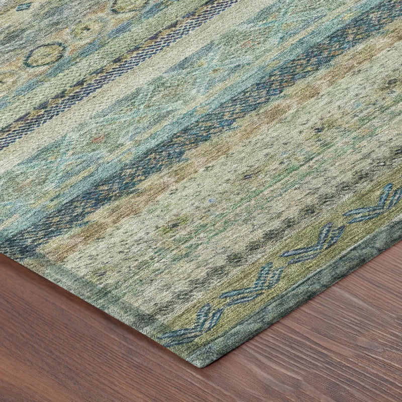 Corner view of striped area rug in muted blue, green, tan, with geometric accents.