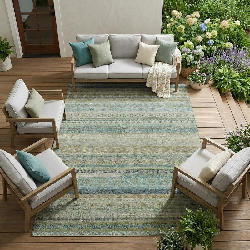 Striped indoor/outdoor area rug under outdoor seating, blue and tan geometric pattern.