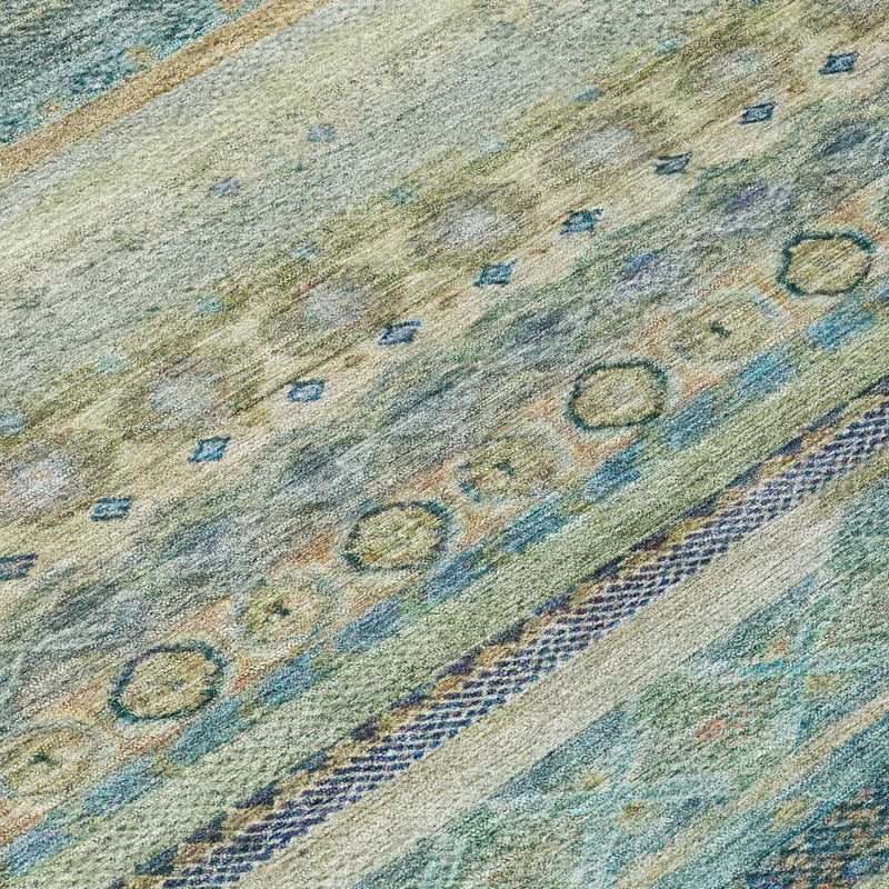 Striped indoor/outdoor area rug with blue, green, and tan geometric motif close-up.