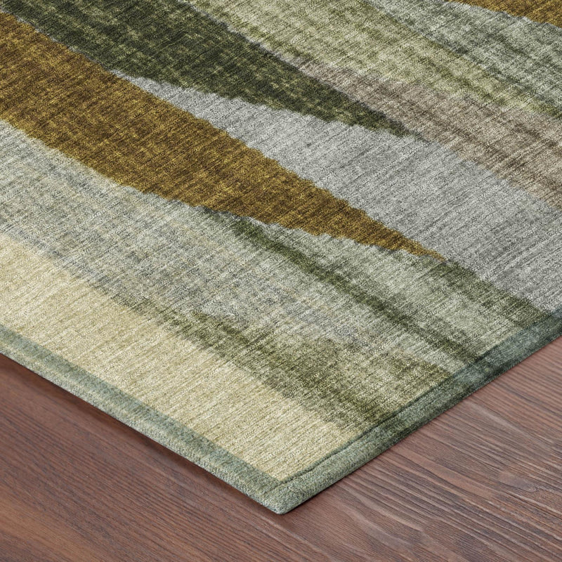 Corner view of striped area rug in gray, mustard, and sage with low pile texture