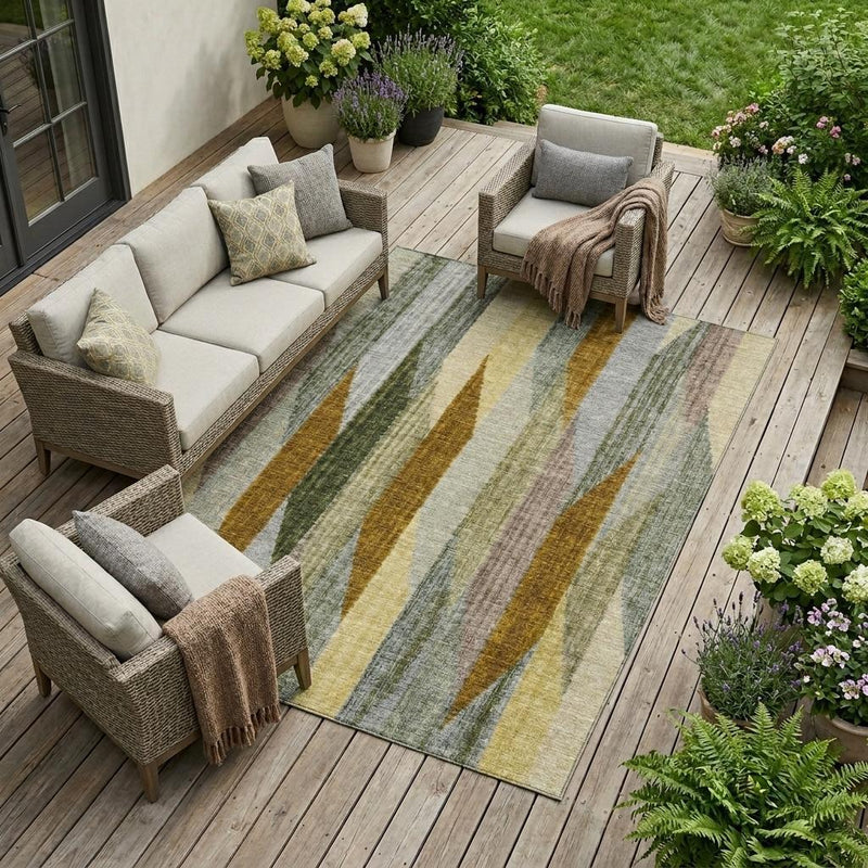 Striped indoor outdoor area rug with gray, sage green, and gold accents on deck.