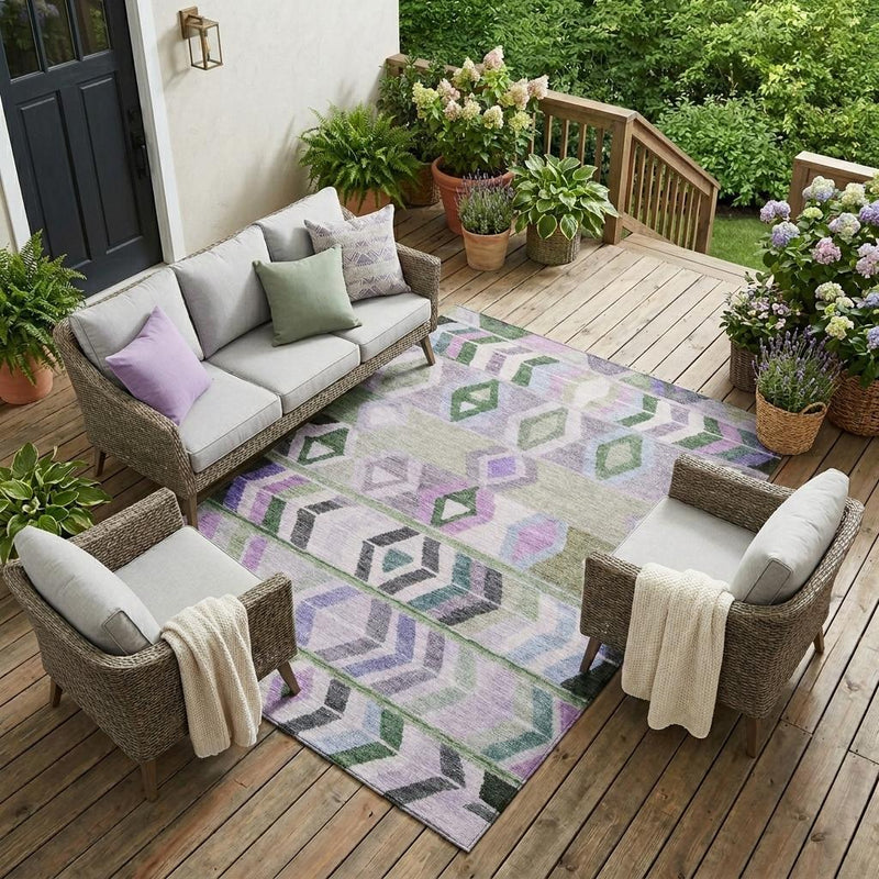 Geometric tribal area rug in lavender, green, and gray on outdoor deck.