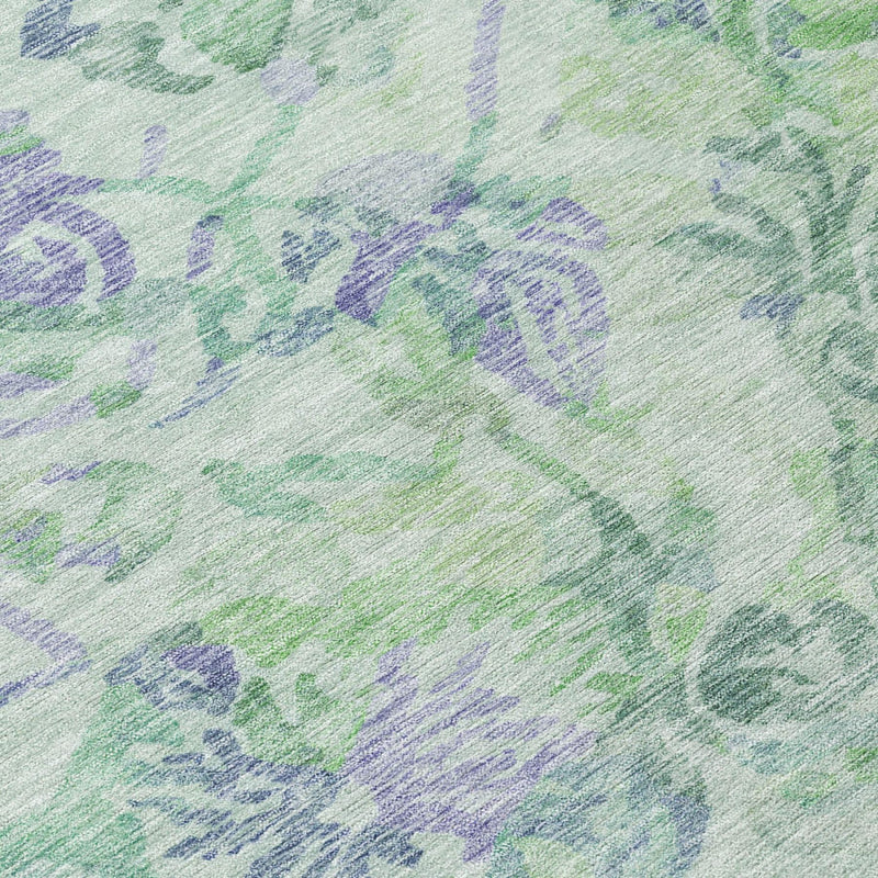 Close-up of floral area rug in mint green with blue-violet botanical pattern