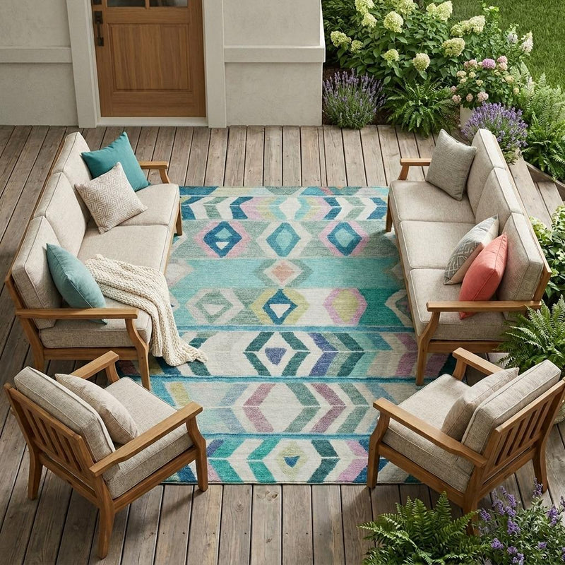 Teal and turquoise tribal area rug with multicolor diamond and arrow patterns, outdoors.