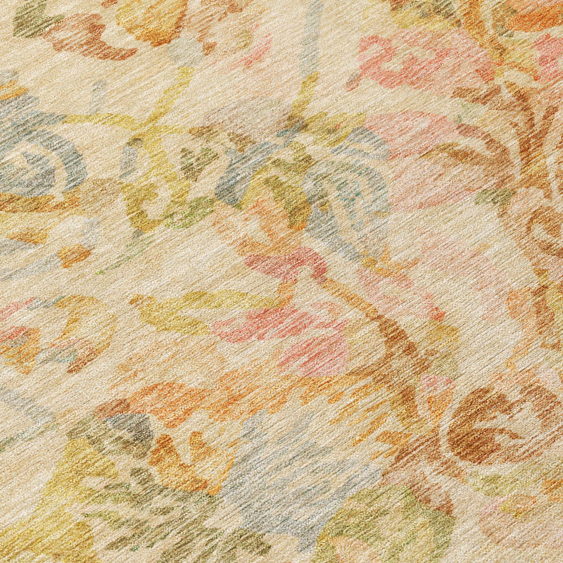 Close-up of multicolor floral area rug texture with peach, orange, and sage tones