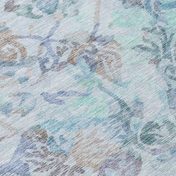 Teal blue area rug with silver floral medallion pattern, short pile