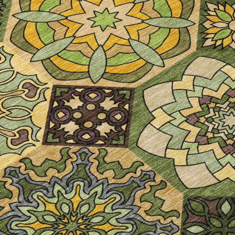 Close-up indoor/outdoor area rug showing patchwork floral and medallion motifs in green