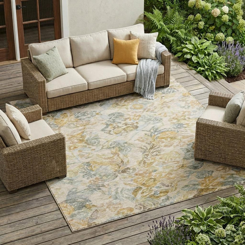 Wheat-and-gold floral area rug with gray motifs, shown under outdoor seating.