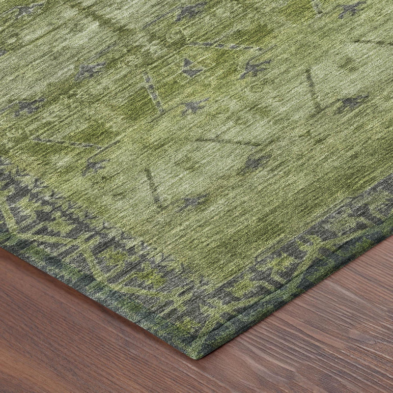 Olive green area rug corner with dark green tribal pattern and low-pile weave
