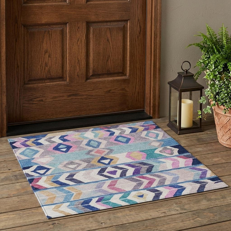 Tribal indoor outdoor area rug in blue, teal, and purple on wood floor