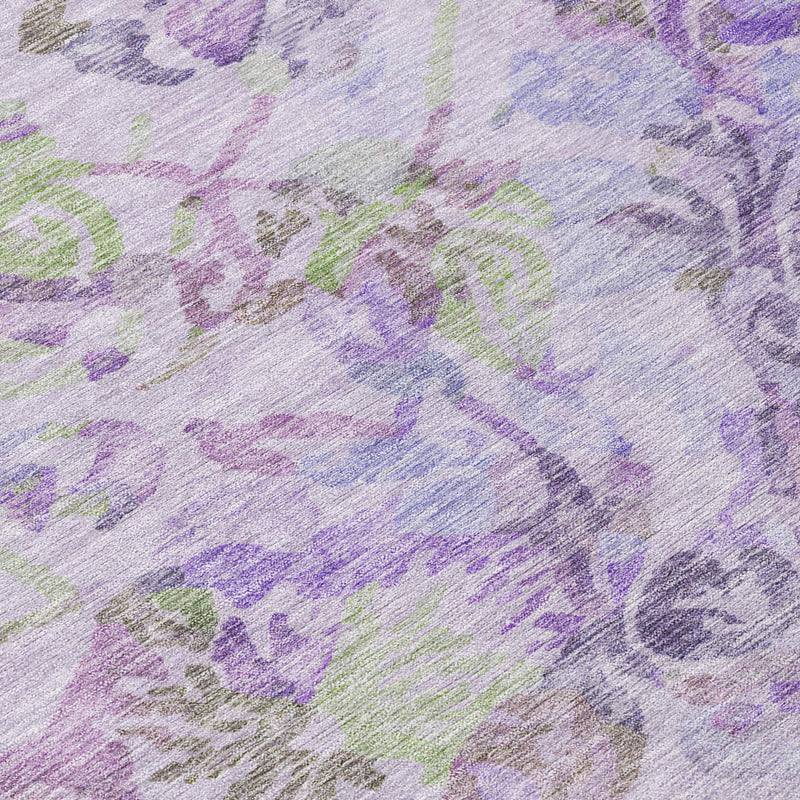 Close-up of lavender floral area rug with purple, green, and blue abstract swirls