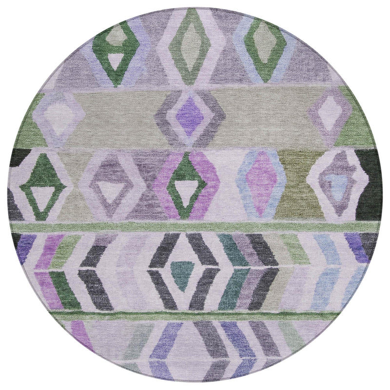 Round indoor outdoor area rug with repeating diamond and arrow tribal pattern in green and lavender.