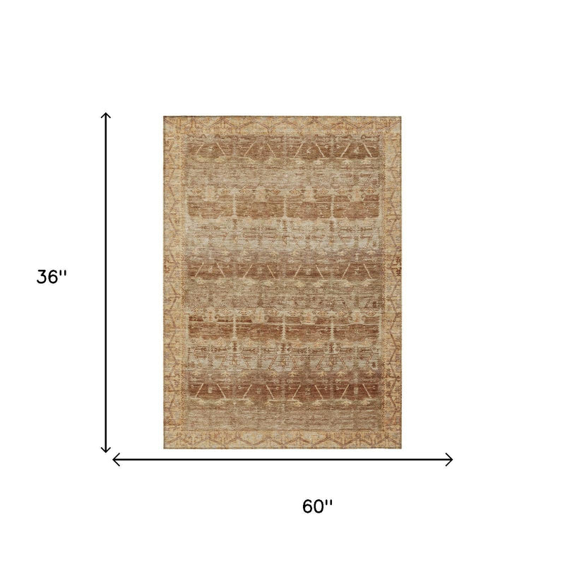 Tan tribal area rug, 36 in x 60 in, distressed geometric pattern in copper