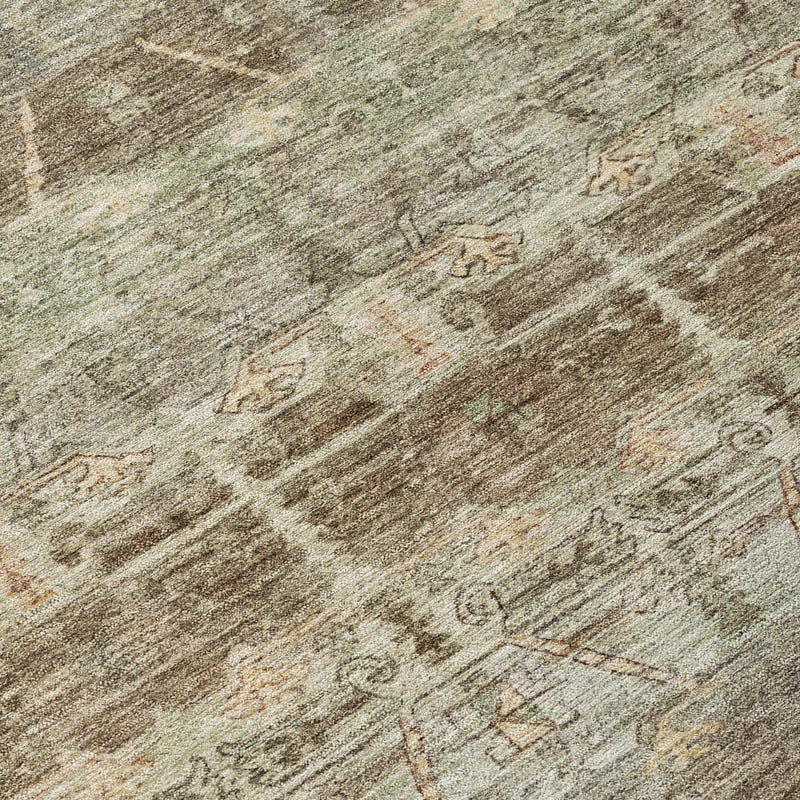 Area rug surface detail with faded tribal lines, mottled beige, sage, and taupe tones.