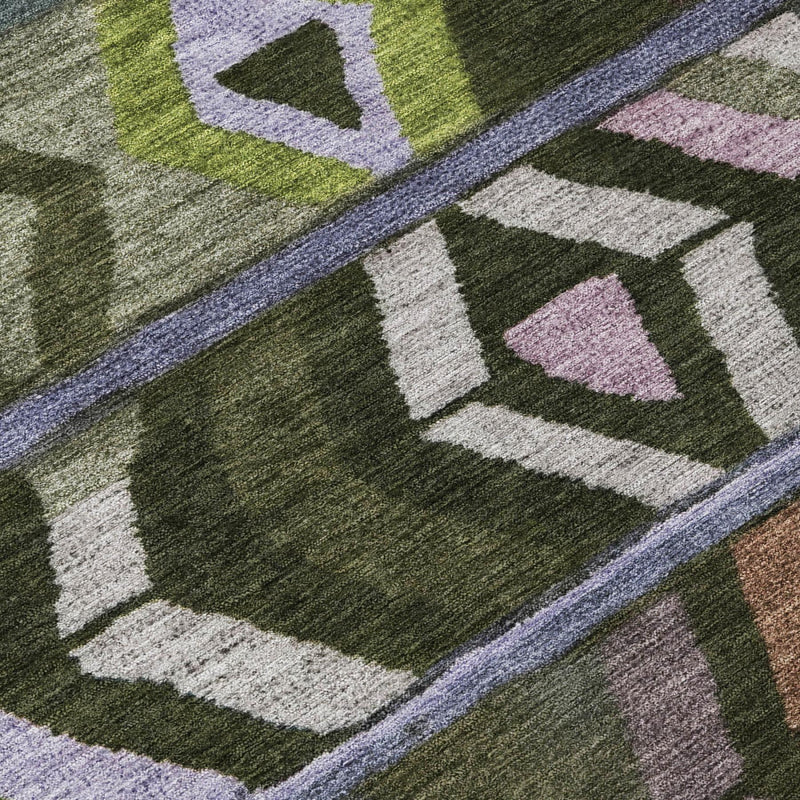 Olive green geometric area rug detail with diamond blocks and purple-gray edging