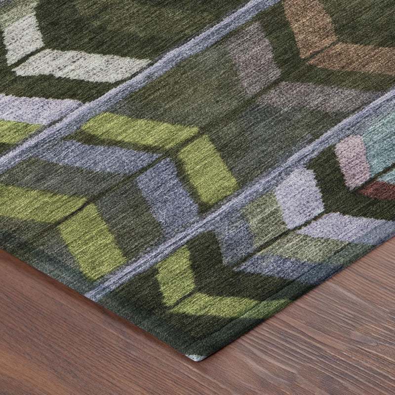 Olive green area rug close-up with geometric shapes and flat woven texture