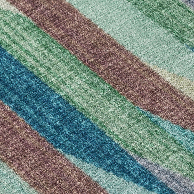 Close-up of round rug fabric with vertical stripes in teal, green, and brown