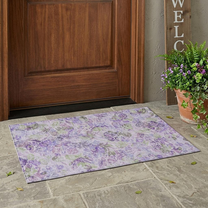 Lavender floral area rug laid flat, plum and purple pattern with green leaf accents