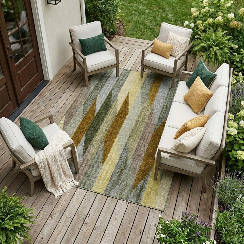 Outdoor area rug with vertical striped design in gray, green, and gold tones on deck