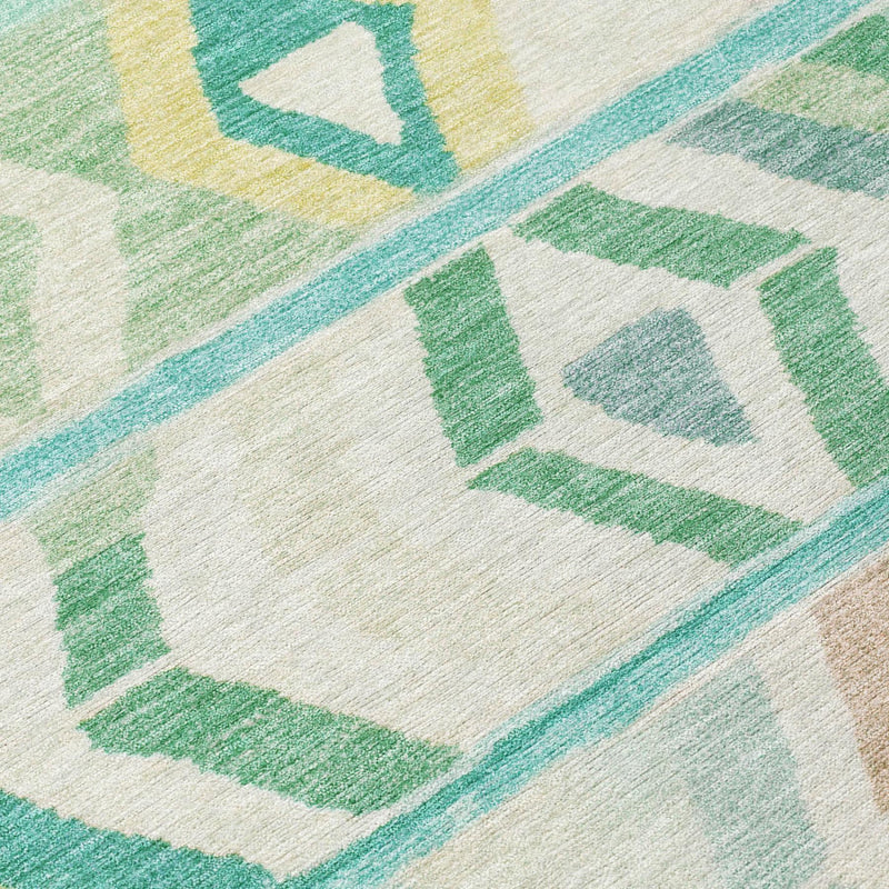 Turquoise and teal tribal area rug close-up with green diamond shapes on cream ground