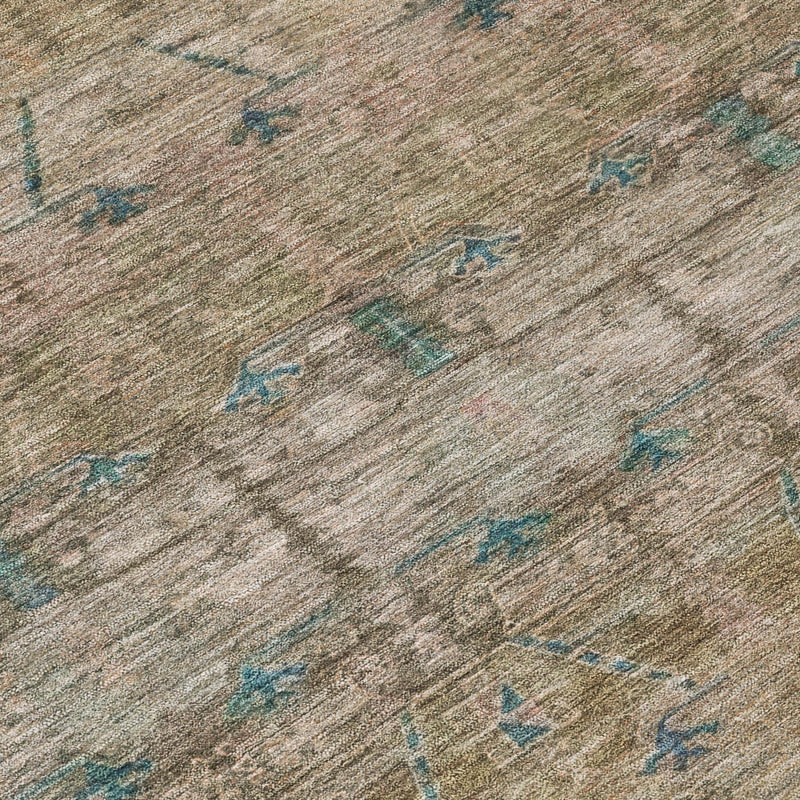 Beige/taupe area rug close-up with teal geometric tribal motifs and textured weave