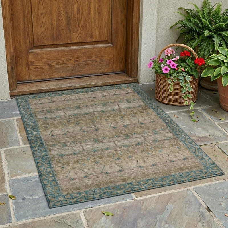 Tribal area rug with taupe background and teal border, laid flat on a floor