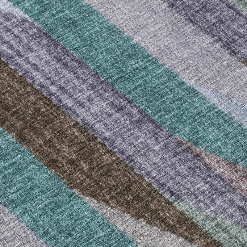 Close-up of striped area rug weave with teal, gray, brown, and blue bands