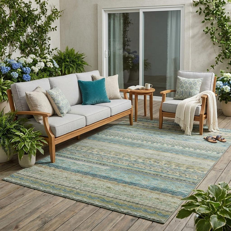 Indoor outdoor area rug with blue and green stripes under patio seating