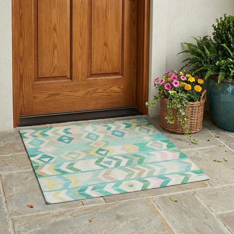 Outdoor-style turquoise and teal tribal geometric area rug on a patio floor