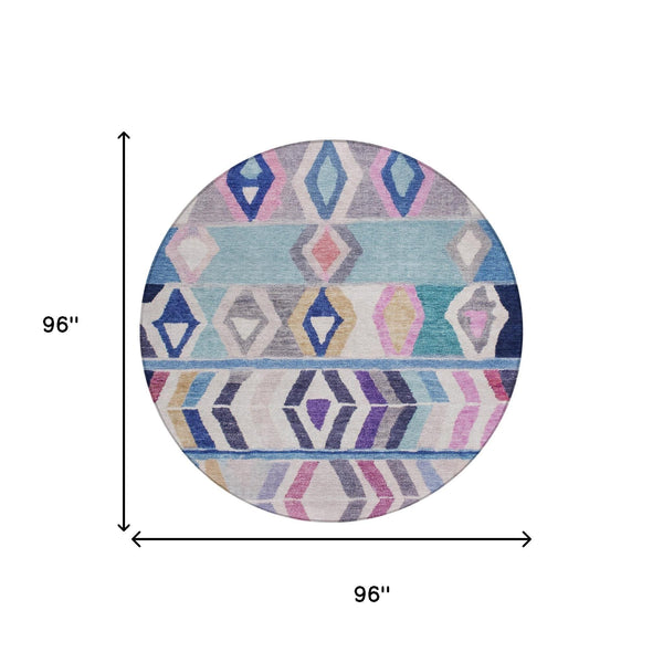 Round area rug with multicolor tribal diamond and zigzag pattern in blue, gray, pink, gold
